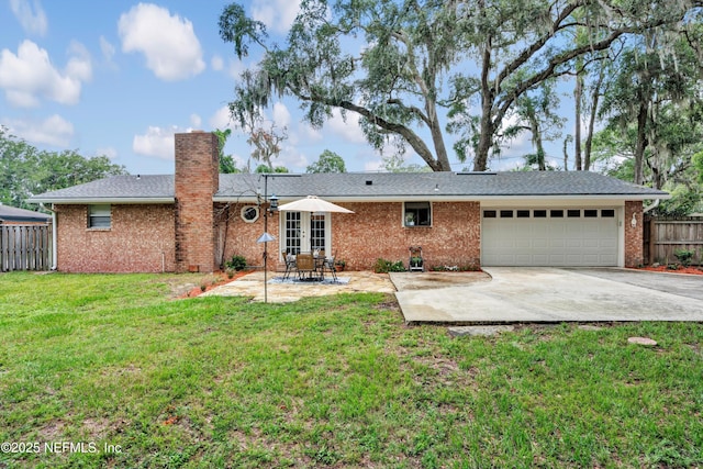 2620 Shenandoah Dr S, Orange Park, FL 32073 - rear view of house featuring an attached garage, a chimney, brick siding, and concrete driveway