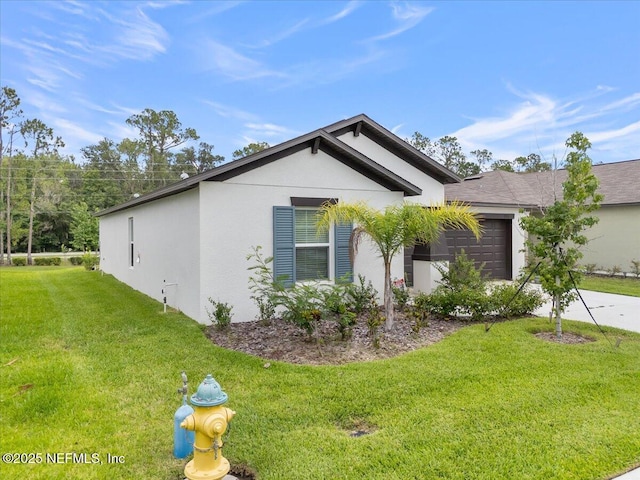 1976 Red Loop, Lakeland, FL 33801 - view of home's exterior featuring stucco siding, a yard, a garage, and driveway