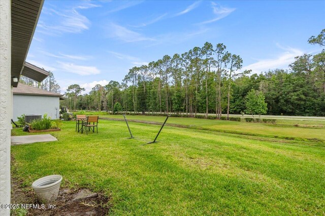 1976 Red Loop, Lakeland, FL 33801 - view of grassy yard with central AC