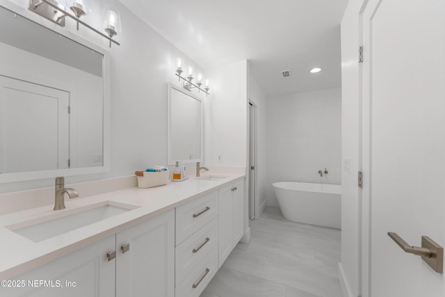 1 Lake Julia Dr S, Ponte Vedra Beach, FL 32082 - full bathroom featuring double vanity, a soaking tub, recessed lighting, and marble look tiles