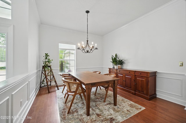 1109 Pine Mill Ln, Ponte Vedra Beach, FL 32082 - dining area featuring healthy amount of natural light, a wainscoted wall, dark wood-type flooring, crown molding, and a chandelier