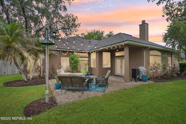1823 Sentry Oak Ct, Fleming Island, FL 32003 - rear view of property with stucco siding, outdoor lounge area, a patio, and a chimney