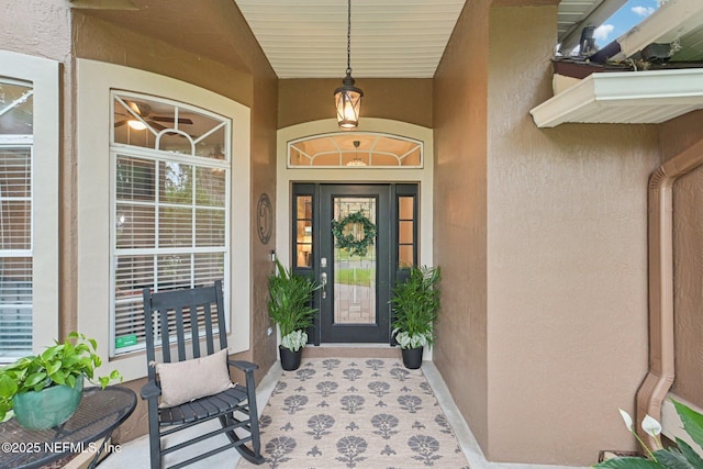 1823 Sentry Oak Ct, Fleming Island, FL 32003 - view of exterior entry with stucco siding and covered porch