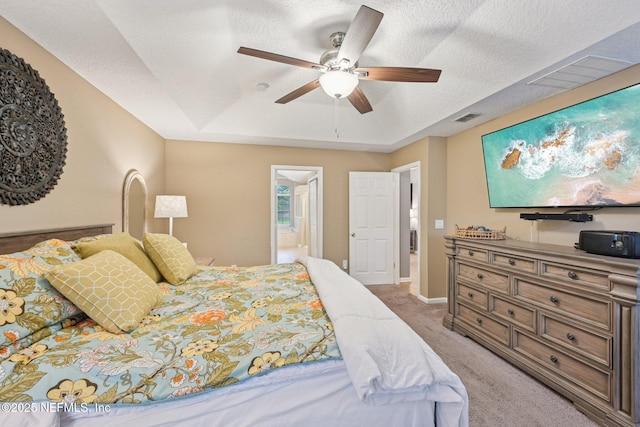 1823 Sentry Oak Ct, Fleming Island, FL 32003 - bedroom with light colored carpet, a tray ceiling, ensuite bathroom, ceiling fan, and baseboards