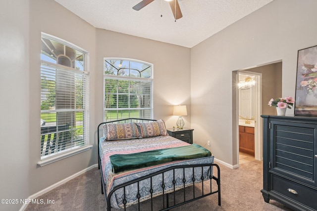 1823 Sentry Oak Ct, Fleming Island, FL 32003 - bedroom featuring light carpet, baseboards, ensuite bathroom, a textured ceiling, and a ceiling fan