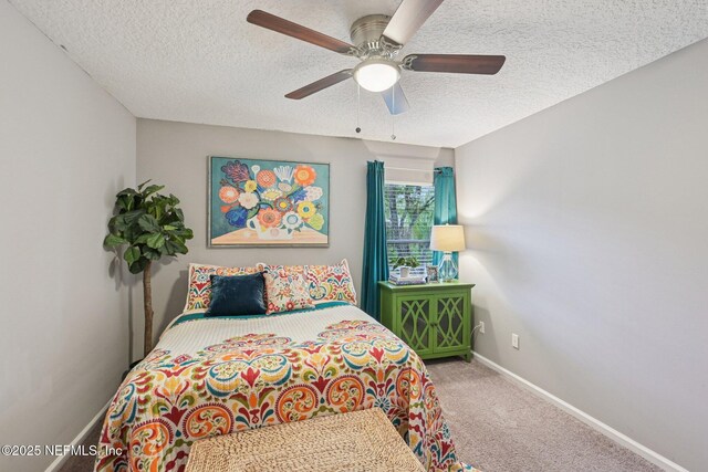 1823 Sentry Oak Ct, Fleming Island, FL 32003 - carpeted bedroom featuring baseboards, a textured ceiling, and ceiling fan