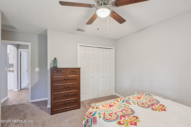 1823 Sentry Oak Ct, Fleming Island, FL 32003 - bedroom featuring carpet floors, a closet, baseboards, a textured ceiling, and a ceiling fan