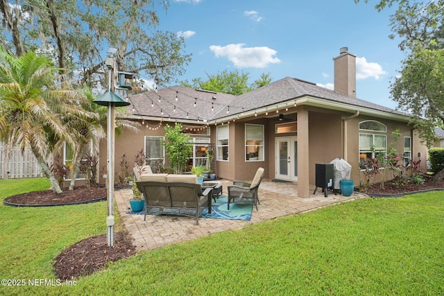 1823 Sentry Oak Ct, Fleming Island, FL 32003 - back of house with stucco siding, outdoor lounge area, a patio, and french doors
