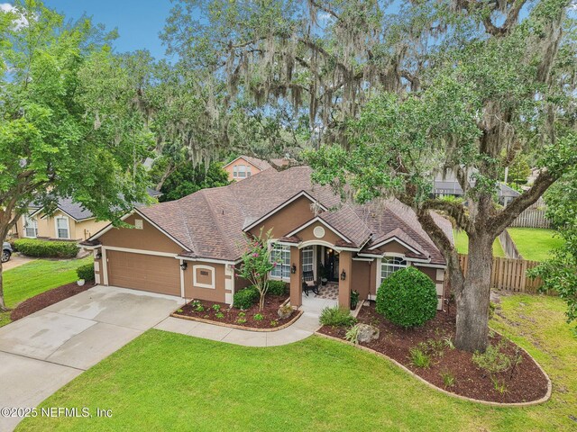 1823 Sentry Oak Ct, Fleming Island, FL 32003 - view of front facade with a shingled roof, stucco siding, a garage, and concrete driveway