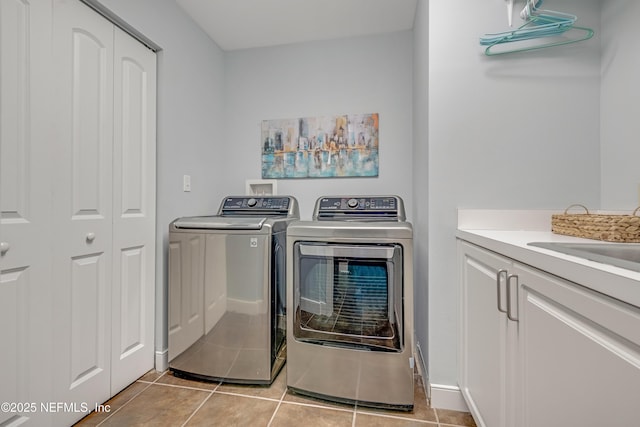 1925 S Atlantic Ave Unit 1005, Daytona Beach Shores, FL 32118 - laundry room featuring cabinet space, separate washer and dryer, and light tile patterned floors