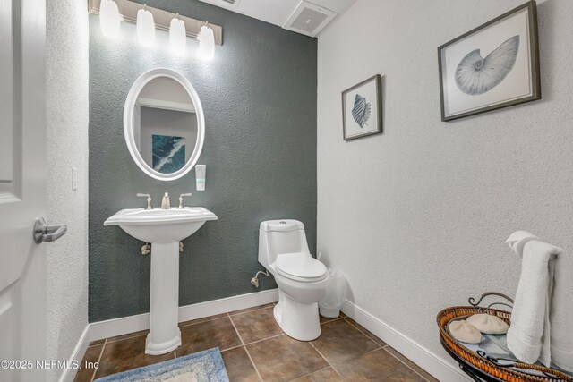 1925 S Atlantic Ave Unit 1005, Daytona Beach Shores, FL 32118 - bathroom featuring tile patterned floors, toilet, and baseboards