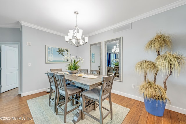 1925 S Atlantic Ave Unit 1005, Daytona Beach Shores, FL 32118 - dining room with a chandelier, crown molding, baseboards, and light wood-style floors