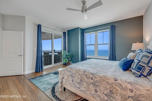 1925 S Atlantic Ave Unit 1005, Daytona Beach Shores, FL 32118 - bedroom featuring access to outside, wood finished floors, a water view, baseboards, and ceiling fan