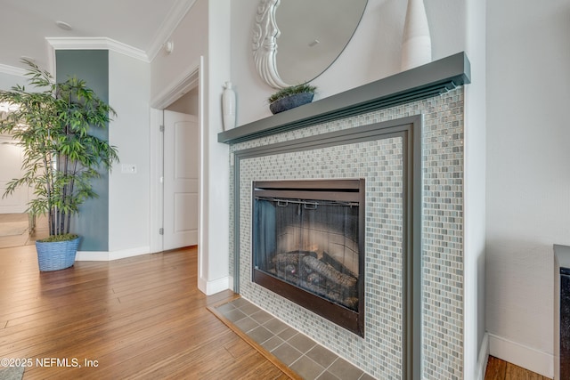 1925 S Atlantic Ave Unit 1005, Daytona Beach Shores, FL 32118 - detailed view of wood finished floors, a tiled fireplace, baseboards, and crown molding