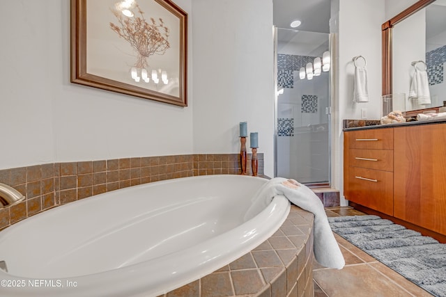 1925 S Atlantic Ave Unit 1005, Daytona Beach Shores, FL 32118 - bathroom with vanity, a stall shower, a garden tub, and tile patterned floors
