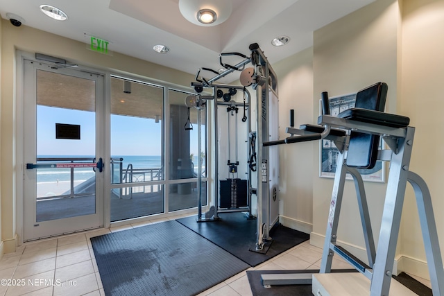 1925 S Atlantic Ave Unit 1005, Daytona Beach Shores, FL 32118 - exercise area featuring tile patterned flooring, a water view, and baseboards
