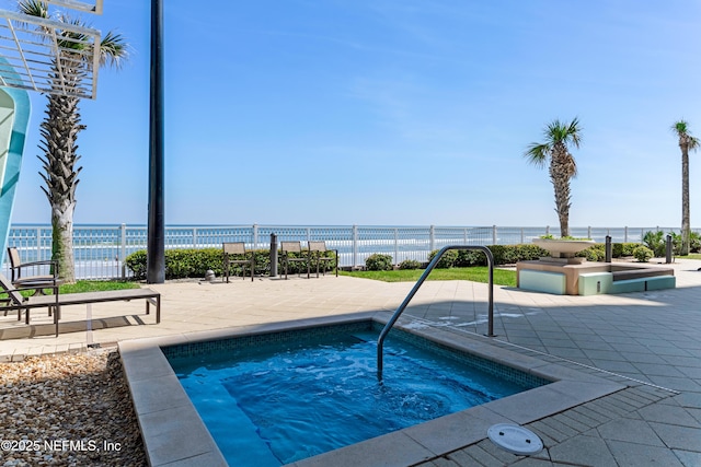 1925 S Atlantic Ave Unit 1005, Daytona Beach Shores, FL 32118 - view of swimming pool featuring a hot tub, a water view, and a patio area
