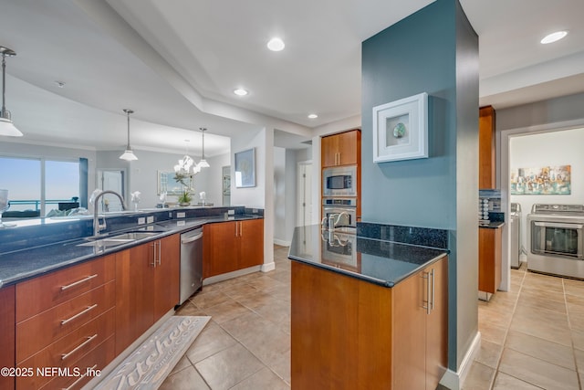1925 S Atlantic Ave Unit 1005, Daytona Beach Shores, FL 32118 - kitchen featuring appliances with stainless steel finishes, a sink, brown cabinetry, dark stone countertops, and light tile patterned floors