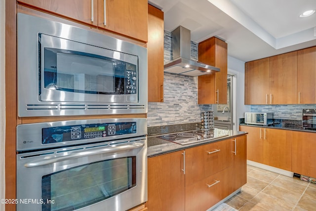 1925 S Atlantic Ave Unit 1005, Daytona Beach Shores, FL 32118 - kitchen with appliances with stainless steel finishes, wall chimney exhaust hood, backsplash, light tile patterned flooring, and a sink