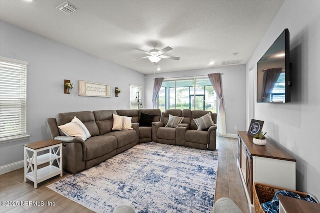 46 Killarney Ave, Saint Johns, FL 32259 - living room featuring wood finished floors, a ceiling fan, baseboards, and a textured ceiling