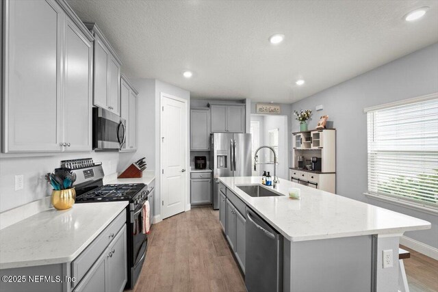 46 Killarney Ave, Saint Johns, FL 32259 - kitchen featuring appliances with stainless steel finishes, a sink, gray cabinets, a center island with sink, and recessed lighting