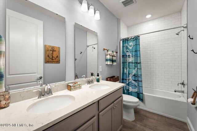46 Killarney Ave, Saint Johns, FL 32259 - full bathroom with wood finished floors, toilet, double vanity, and shower / tub combo