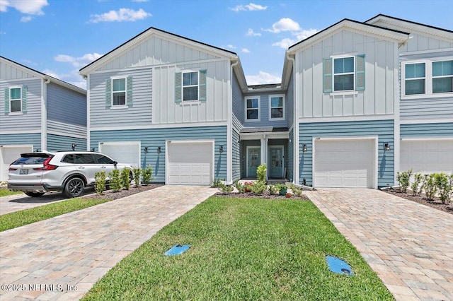 233 Brandon Lakes Dr, Saint Augustine, FL 32092 - view of front facade featuring board and batten siding, a garage, and driveway
