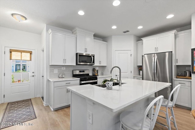 233 Brandon Lakes Dr, Saint Augustine, FL 32092 - kitchen featuring appliances with stainless steel finishes, a sink, decorative backsplash, light countertops, and recessed lighting