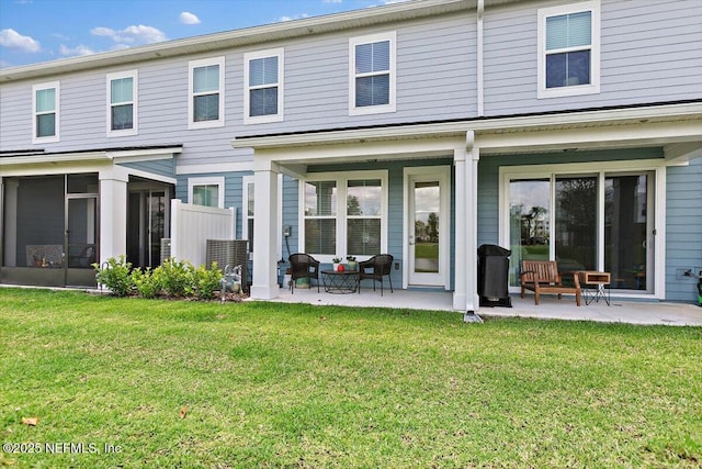 233 Brandon Lakes Dr, Saint Augustine, FL 32092 - rear view of house with a patio, a yard, and a sunroom