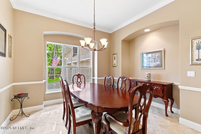 69 Bridle Ridge Ct, Flagler Beach, FL 32136 - dining space with ornamental molding, a chandelier, light tile patterned floors, baseboards, and arched walkways