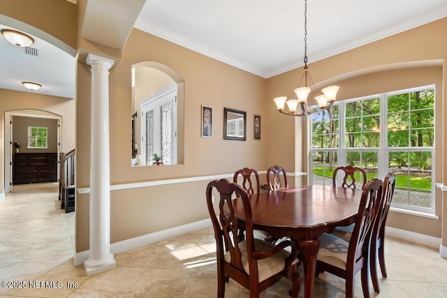 69 Bridle Ridge Ct, Flagler Beach, FL 32136 - dining room with ornate columns, plenty of natural light, crown molding, baseboards, and a chandelier