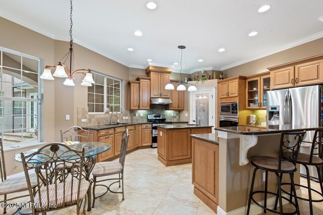 69 Bridle Ridge Ct, Flagler Beach, FL 32136 - kitchen with appliances with stainless steel finishes, a center island, recessed lighting, a sink, and decorative backsplash