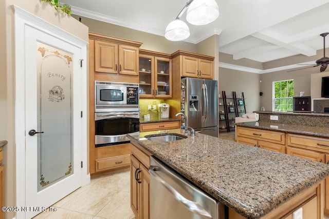 69 Bridle Ridge Ct, Flagler Beach, FL 32136 - kitchen with appliances with stainless steel finishes, a sink, a center island with sink, dark stone counters, and glass insert cabinets