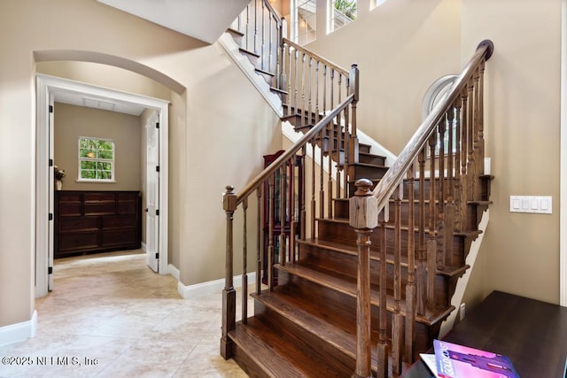 69 Bridle Ridge Ct, Flagler Beach, FL 32136 - stairway with baseboards and arched walkways