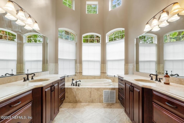 69 Bridle Ridge Ct, Flagler Beach, FL 32136 - bathroom with plenty of natural light, two vanities, a bath, and a high ceiling