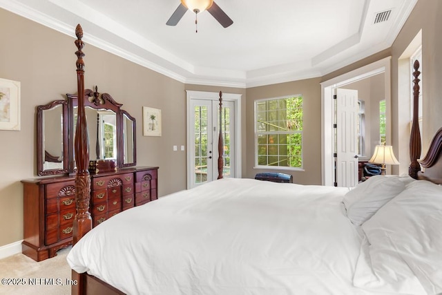 69 Bridle Ridge Ct, Flagler Beach, FL 32136 - bedroom with access to exterior, a tray ceiling, and a ceiling fan