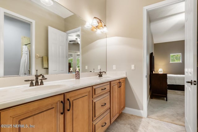 69 Bridle Ridge Ct, Flagler Beach, FL 32136 - full bath with double vanity, ceiling fan, ensuite bath, tile patterned flooring, and baseboards