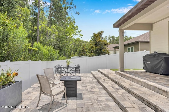 145 Sailors Landing Ct, Saint Augustine, FL 32084 - fenced backyard with a patio, a grill, and outdoor dining area