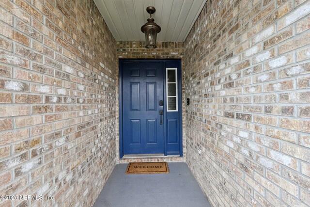 12357 Winterpine Ct, Jacksonville, FL 32225 - view of exterior entry featuring brick siding