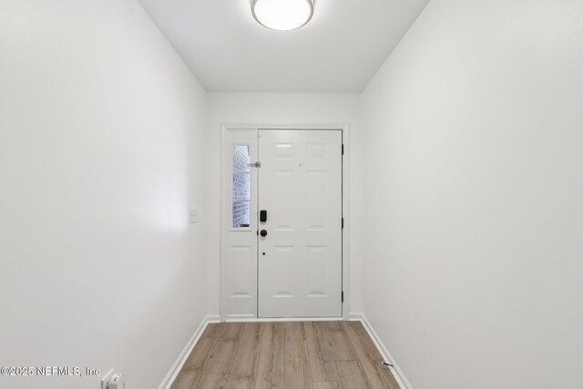12357 Winterpine Ct, Jacksonville, FL 32225 - doorway with light wood-style flooring and baseboards
