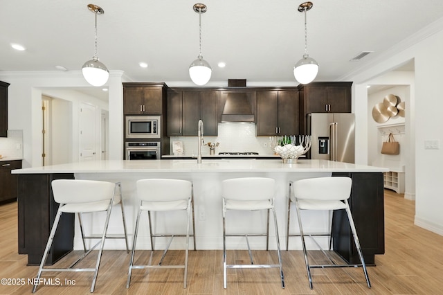 96 Glenhurst Ave, Ponte Vedra, FL 32081 - kitchen featuring stainless steel appliances, ornamental molding, custom range hood, backsplash, and light wood-style flooring