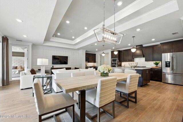 96 Glenhurst Ave, Ponte Vedra, FL 32081 - dining area with a raised ceiling, crown molding, light wood-style floors, and recessed lighting