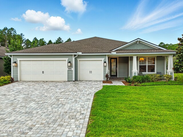 96 Glenhurst Ave, Ponte Vedra, FL 32081 - view of front facade with decorative driveway, an attached garage, a front yard, a porch, and a shingled roof