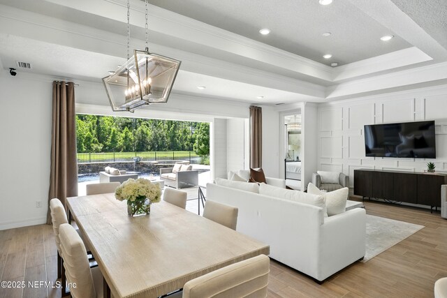 96 Glenhurst Ave, Ponte Vedra, FL 32081 - dining room with ornamental molding, a chandelier, a tray ceiling, light wood-type flooring, and recessed lighting