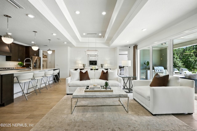 96 Glenhurst Ave, Ponte Vedra, FL 32081 - living room with light wood-type flooring, crown molding, recessed lighting, and a tray ceiling
