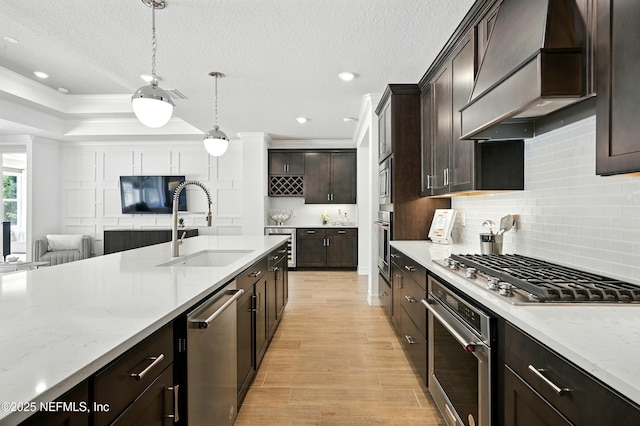 96 Glenhurst Ave, Ponte Vedra, FL 32081 - kitchen featuring stainless steel appliances, premium range hood, open floor plan, backsplash, and light wood-type flooring