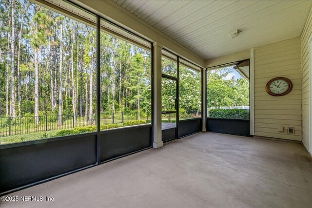 27 Shady Lake Ct, Saint Augustine, FL 32095 - unfurnished sunroom featuring a view of trees