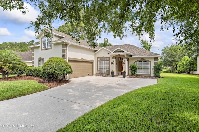 4340 Comanche Trail Blvd, Saint Johns, FL 32259 - view of front of home with stucco siding, concrete driveway, a front lawn, roof with shingles, and a garage