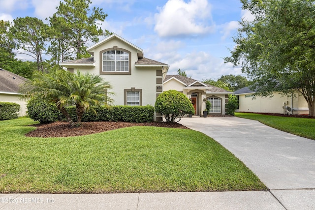 4340 Comanche Trail Blvd, Saint Johns, FL 32259 - view of front of house featuring driveway, stucco siding, and a front lawn