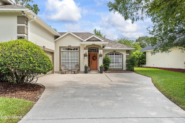 4340 Comanche Trail Blvd, Saint Johns, FL 32259 - view of front facade with stucco siding, a shingled roof, and a front lawn